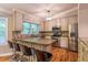 Bright kitchen featuring granite countertops, stainless steel appliances and counter seating on hardwood flooring at 4655 Barnes Ct, Loganville, GA 30052