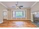 Spacious living room featuring hardwood floors, bay window, fireplace, and neutral paint at 4655 Barnes Ct, Loganville, GA 30052