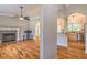 Spacious living room featuring a fireplace, hardwood floors, and views of the kitchen at 4655 Barnes Ct, Loganville, GA 30052
