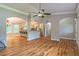 Open concept living space with hardwood floors flowing into the kitchen and featuring decorative arches at 4655 Barnes Ct, Loganville, GA 30052