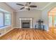 Open living room with hardwood flooring, large bay window, fireplace and vaulted ceilings at 4655 Barnes Ct, Loganville, GA 30052