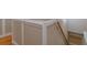 Close-up of a classic staircase with paneled walls and a wooden handrail at 4655 Barnes Ct, Loganville, GA 30052