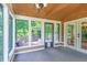 Relaxing sunroom with wooded views and access to an outdoor deck at 4655 Barnes Ct, Loganville, GA 30052