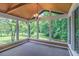 Relaxing sunroom with wooded views, large windows, and a vaulted ceiling at 4655 Barnes Ct, Loganville, GA 30052