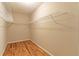 Walk-in closet features hardwood floors and wire shelving for clothing and storage at 4655 Barnes Ct, Loganville, GA 30052