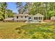 Expansive backyard with a patio, outdoor furniture, and lush green grass at 4794 Glenbonnie Ct, Atlanta, GA 30360