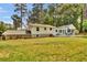 Large backyard with a patio, outdoor furniture, and mature trees providing shade at 4794 Glenbonnie Ct, Atlanta, GA 30360