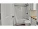 Clean bathroom featuring a shower-tub, white tile, and a marble countertop sink at 4794 Glenbonnie Ct, Atlanta, GA 30360