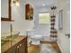 Well-lit bathroom with unique glass sink, tiled floor, and shower-tub combo at 4794 Glenbonnie Ct, Atlanta, GA 30360