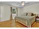 Bright bedroom with hardwood floors, a ceiling fan, and a queen size bed at 4794 Glenbonnie Ct, Atlanta, GA 30360