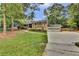 Spacious two-story home with a large front yard, attached two-car garage, and mature trees at 4794 Glenbonnie Ct, Atlanta, GA 30360