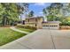 Beautiful two-story home with a large driveway, mature trees, and attached garage at 4794 Glenbonnie Ct, Atlanta, GA 30360