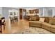 Open concept living area with wood floors, couch and view into the kitchen area at 4794 Glenbonnie Ct, Atlanta, GA 30360