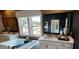 A luxurious bathroom features a soaking tub, dual vanities, and stylish wood-look tile walls at 4820 Gadwall Way, Cumming, GA 30028