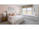 A charming bedroom with a built-in window seat, soft pink walls, and stylish decor at 4820 Gadwall Way, Cumming, GA 30028