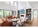 A spacious, light-filled living room with a fireplace, built-in shelves, and sliding doors to the outdoor space at 4820 Gadwall Way, Cumming, GA 30028