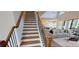 Elegant stairway view of the open-concept living room and kitchen, featuring hardwood stairs and modern decor at 4820 Gadwall Way, Cumming, GA 30028