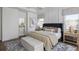 A serene main bedroom boasts a plush bed, elegant furnishings, and abundant natural light from the windows at 4820 Gadwall Way, Cumming, GA 30028