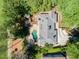 This home features a kidney bean-shaped pool and in-ground fire pit, complemented by mature landscaping at 511 Pine Valley Se Rd, Marietta, GA 30067