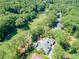 Aerial view of a luxury home nestled among mature trees and golf course at 511 Pine Valley Se Rd, Marietta, GA 30067
