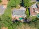 Expansive home features an in-ground pool with a stone patio, lush landscaping, and a private driveway at 511 Pine Valley Se Rd, Marietta, GA 30067