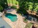 Aerial view of a kidney-shaped pool, outdoor living space, and mature landscaping at 511 Pine Valley Se Rd, Marietta, GA 30067