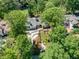 Aerial view of ranch-style home with a long driveway, surrounded by lush greenery, near a golf course at 511 Pine Valley Se Rd, Marietta, GA 30067