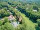 Aerial shot showcasing a house overlooking a lush green golf course and surrounding trees at 511 Pine Valley Se Rd, Marietta, GA 30067