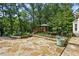 Beautiful stone patio with lush landscaping, wooden bridge, and gazebo creating an outdoor oasis at 511 Pine Valley Se Rd, Marietta, GA 30067