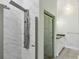 Luxurious bathroom featuring sleek marble tiles and modern shower system at 511 Pine Valley Se Rd, Marietta, GA 30067