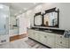 Well-lit bathroom with double vanity, stylish mirrors, and ample cabinet space at 511 Pine Valley Se Rd, Marietta, GA 30067