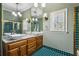 Bright bathroom boasts a dual sink vanity, decorative tile floor, and a shower with glass doors at 511 Pine Valley Se Rd, Marietta, GA 30067
