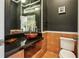 Chic powder room featuring unique vanity, designer bowl sink, and modern fixtures at 511 Pine Valley Se Rd, Marietta, GA 30067