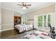 Serene bedroom boasts hardwood floors, large windows with backyard views, and a peaceful setting at 511 Pine Valley Se Rd, Marietta, GA 30067