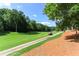 Picturesque view of a golf course with lush green fairways, mature trees, and a winding cart path at 511 Pine Valley Se Rd, Marietta, GA 30067
