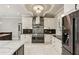This kitchen features a stainless steel refrigerator, a range hood, and marble countertops at 511 Pine Valley Se Rd, Marietta, GA 30067