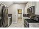 Updated kitchen with stainless steel appliances, granite countertops, and tile floors at 511 Pine Valley Se Rd, Marietta, GA 30067