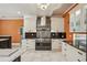 A gourmet kitchen showcases a stainless steel range, modern hood, and custom cabinets at 511 Pine Valley Se Rd, Marietta, GA 30067