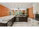 The well-lit kitchen features stone countertops, custom cabinets, and stainless appliances at 511 Pine Valley Se Rd, Marietta, GA 30067