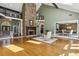 An open living area with a stone fireplace, and a view into a dining area and entrance with double doors at 511 Pine Valley Se Rd, Marietta, GA 30067