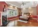 Spacious main bedroom featuring a fireplace, bay window, tray ceiling, and hardwood floors at 511 Pine Valley Se Rd, Marietta, GA 30067
