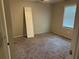 Cozy bedroom features neutral carpeting and natural light, providing a comfortable and versatile space at 915 Lake Dr, Snellville, GA 30039