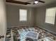 Bright bedroom with unique tile flooring, ceiling fan and natural light from dual windows, offering a cozy retreat at 915 Lake Dr, Snellville, GA 30039