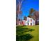 Striking exterior view of modern home with a bright red door, complemented by lush green lawn at 2645 Shadow Woods Circle Ne, Marietta, GA 30062
