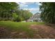 Expansive backyard with lush greenery, mature trees, and an inviting in-ground pool for summer enjoyment at 285 Aspen Way, Fayetteville, GA 30214