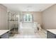 Spacious bathroom with a soaking tub, a separate tiled shower, and a double vanity, perfect for relaxation at 285 Aspen Way, Fayetteville, GA 30214