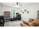 Bedroom featuring neutral-toned walls, carpeted floors, a window providing views, ceiling fan and a sofa at 285 Aspen Way, Fayetteville, GA 30214
