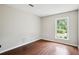 Bedroom with hardwood floors, a large window offering natural light and providing serene neighborhood views at 285 Aspen Way, Fayetteville, GA 30214