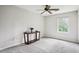 Bedroom featuring neutral-toned walls, carpeted floors, a window providing views and a ceiling fan at 285 Aspen Way, Fayetteville, GA 30214