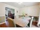 A spacious dining room with a wooden table, upholstered chairs, and a view into the living room at 285 Aspen Way, Fayetteville, GA 30214